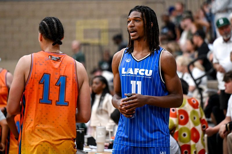 Team LAFCUâ€™s and Michigan State's Ethan Taylor, right, talks with MSU teammate Jesse McCulloch during the Moneyball Pro-Am on Thursday, June 25, 2026, at Holt High School.