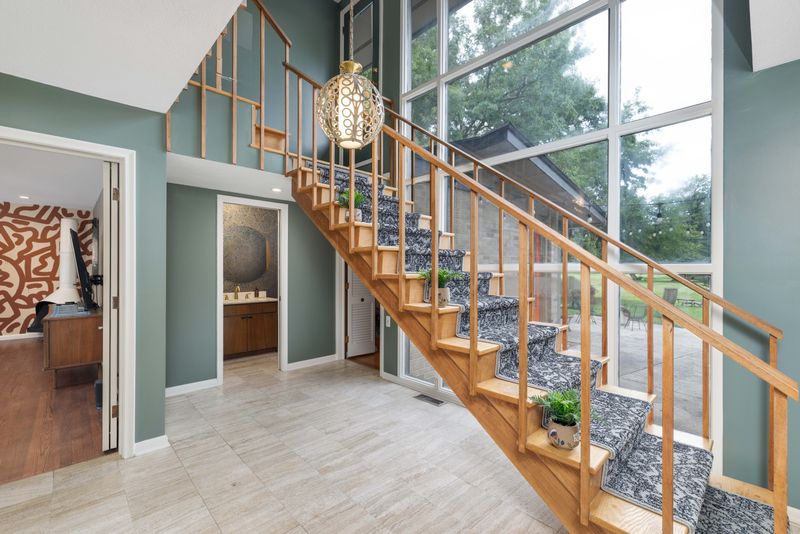 Listing photo show the interior of the mid-century modern home at 2771 W. Seven Mile Road in Detroit, which retains many of its original architectural features. The home, once owned by the family behind Faygo, is listed for $700,000.