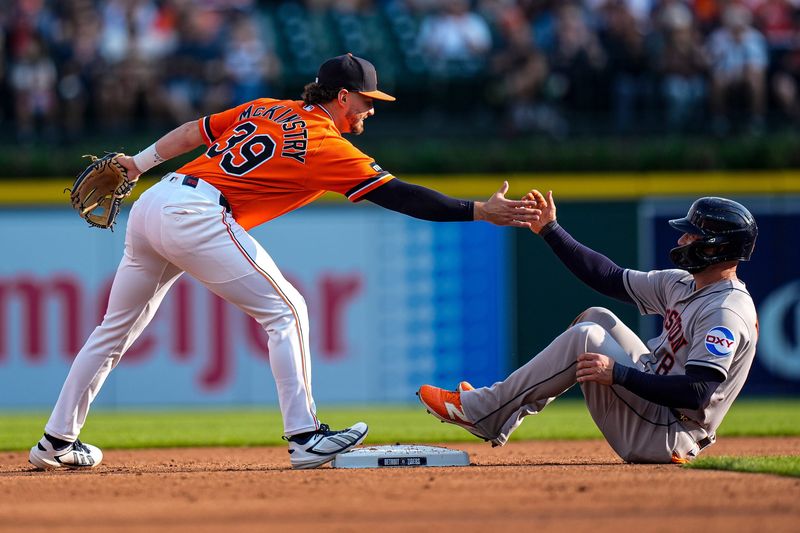Detroit Tigers second baseman Zach McKinstry (39) helps pick up Houston Astros first baseman Christian Walker (8) after Walker is out on second base during the second inning at Comerica Park in Detroit on Friday, June 26, 2026.
