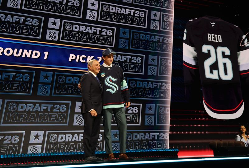 Chase Reid reacts beside NHL commissioner Gary Bettman after being selected with the seventh pick in the first round of the 2026 NHL Draft by the Seattle Kraken at KeyBank Center in Buffalo, New York, on Friday, June 26, 2026.