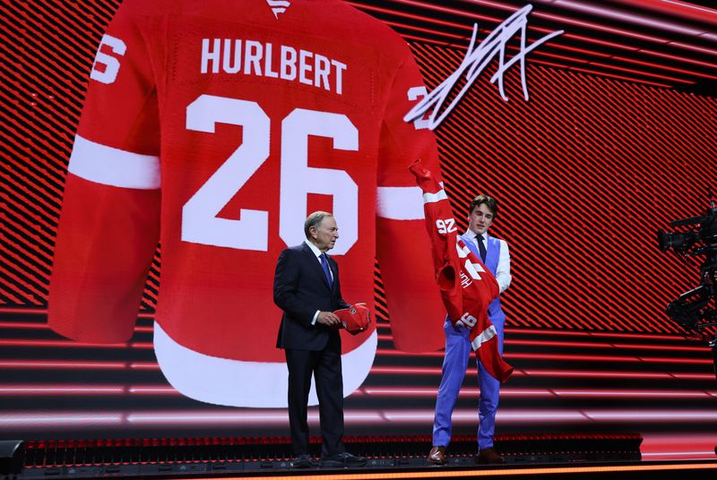 JP Hurlbert reacts beside NHL commissioner Gary Bettman after being selected with the twenty third pick in the first round of the 2026 NHL Draft by the Detroit Red Wings on Friday, June 26, 2026 at KeyBank Center in Buffalo, New York.
