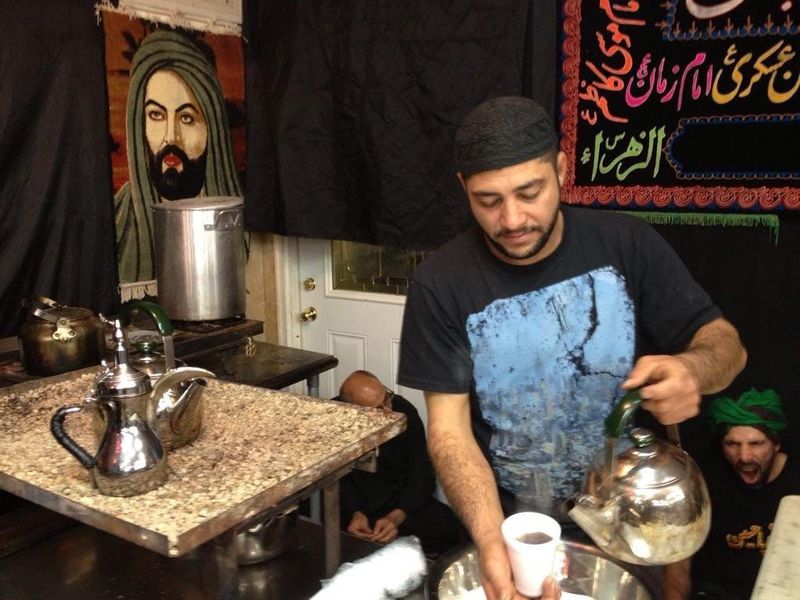 A man serves tea to congregants during Ashura services at the Imam Ali Islamic Center in Detroit in November 2014.