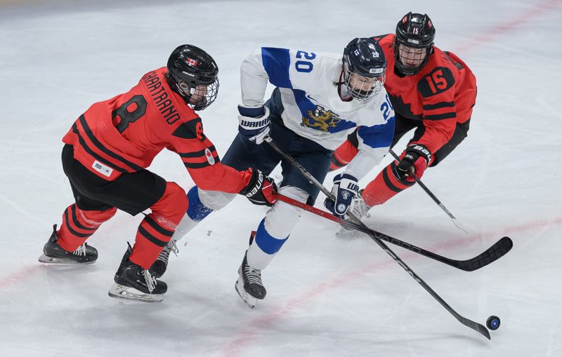 Cameron Chartrand (CAN) and Braidy Wassilyn (CAN) compete as Luka Arkko (FIN) skates with the puck in the Ice Hockey Men’s 6-on-6 Tournament Bronze Medal Game between Canada and Finland at the Gangneung Hockey Centre. The Winter Youth Olympic Games, Gangwon, South Korea on Wednesday, Jan. 31, 2024.