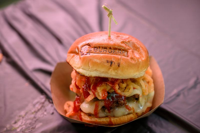 BurgerFi won the 10th annual Burger Battle Detroit with the Rodeo Burger featuring Angus beef patties topped with barbecue sauce, charred jalapeños, peppers, jack cheese and fried onion crisps with a "bit of sweet heat" on a soft BurgerFi-branded bun at Eastern Market on Sunday.