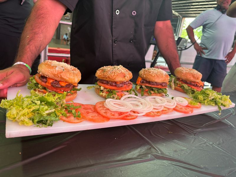 Koney King presents its burger to a panel of judges at the Burger Battle Detroit at Eastern Market on Sunday, June 28, 2026.
