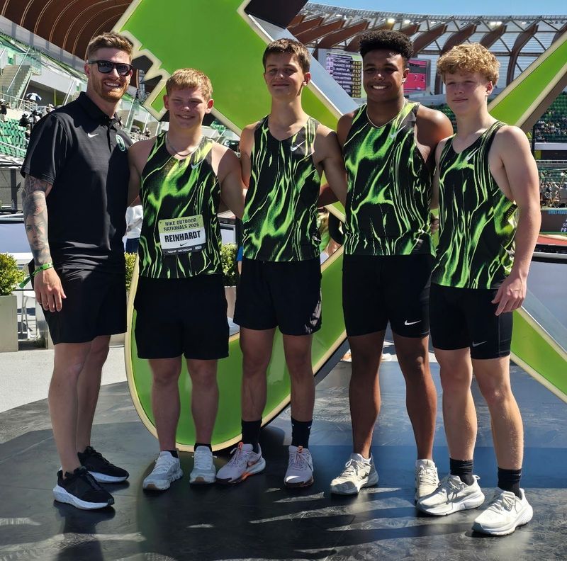 St. Mary Catholic Central track and field coach Roman Smith poses for a photo with his state-championship 400-meter relay team of Cole Reinhardt, Gavin Swartout, Vince Harris and Brady Reinhardt.