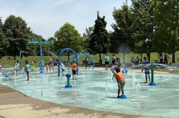 Children play in the water at a splash pad on Monday, June 29, 2026, at Heritage Park in Farmington Hills.