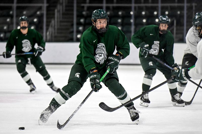 Michigan State's Sean Barnhill moves the puck during hockey practice on Thursday, Sept. 25, 2025, at Munn Arena in East Lansing.