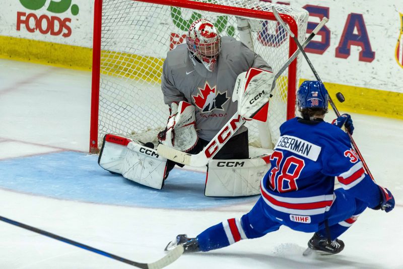 Aug 3, 2024; Plymouth, MI, USA; Canada's goaltender Joshua Ravensbergen (31) makes a save on a shot from USA’s forward Cole Eiserman (38) during the second period of the 2024 World Junior Summer Showcase at USA Hockey Arena. Mandatory Credit: David Reginek-USA TODAY Sports