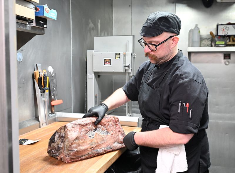 Butcher Nick Weber talks about the piece of dry aged beef  that he is about to cut into steaks on June 30, 2026 at Prime + Proper Steakhouse in Detroit.