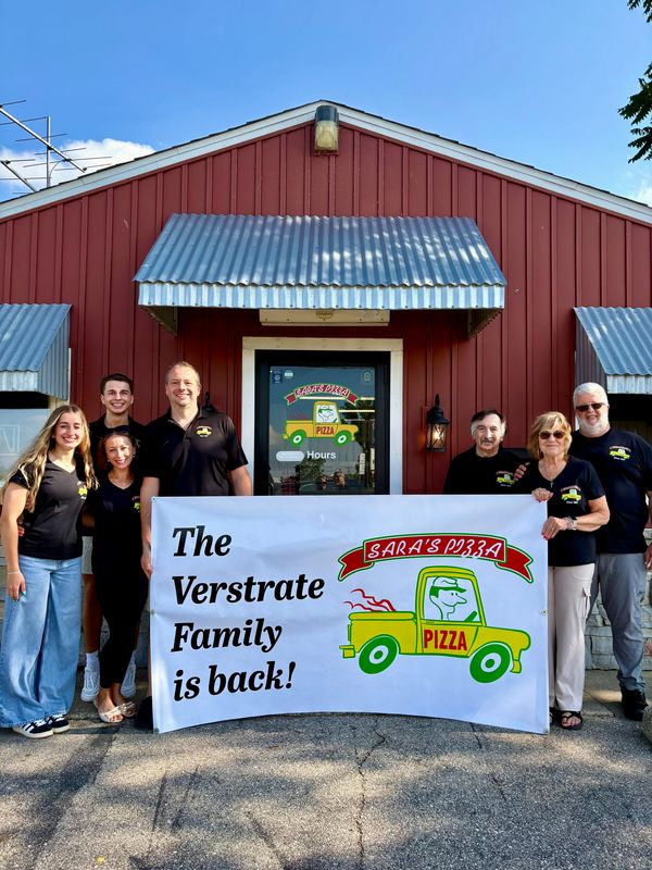 Mike Verstrate (center left) and his family have taken over Sara's Pizza in Hudsonville.