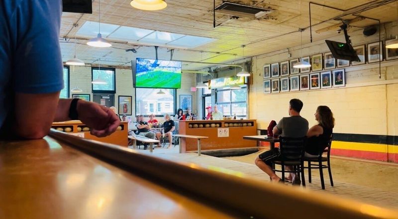 Soccer fans sit near a feather bowling lane to watch the USA vs. Belgium at Cadieux Cafe, a Belgian Bar on Detroit's east side.