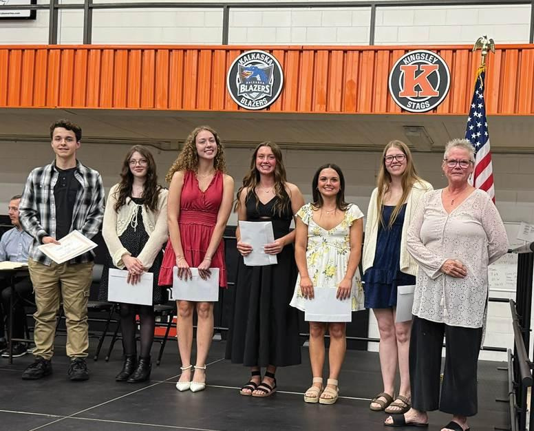 SACF Board President Linda Rogers (far right) presents scholarships to Cheboygan High School graduating seniors at their spring awards night.