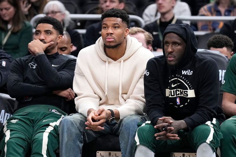 Mar 17, 2026; Milwaukee, Wisconsin, USA; Milwaukee Bucks guard Gary Harris (11), left, Milwaukee Bucks forward Giannis Antetokounmpo (34) and Milwaukee Bucks forward Taurean Prince (12) watch the game against the Cleveland Cavaliers from the bench in the second half at Fiserv Forum. Mandatory Credit: Michael McLoone-Imagn Images