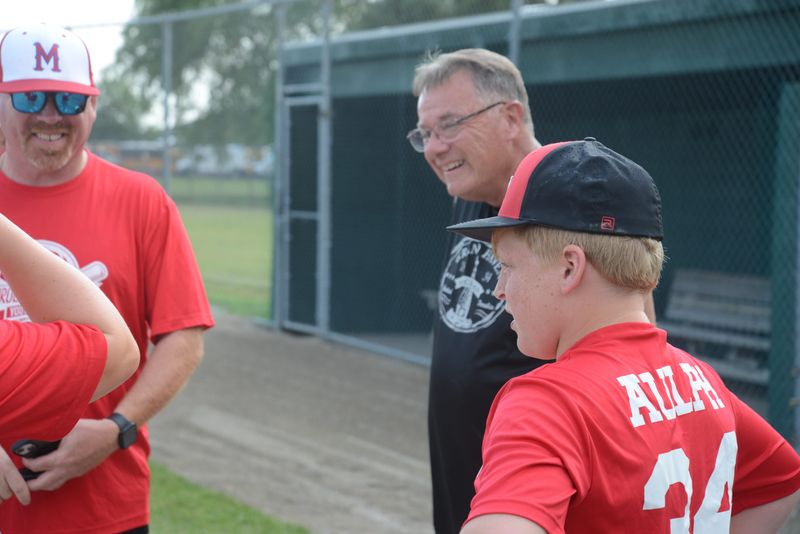 Co-tournament director Dave Peters talks with Bill, Alana and Nolan Aulph during media day for the Monroe County Fair Softball and Baseball Tournaments on Tuesday, July 7, 2026.