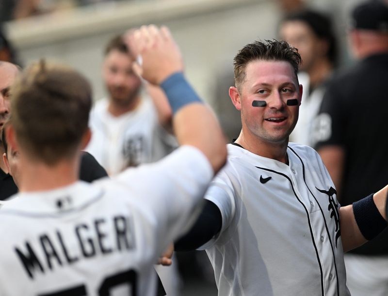 Tigers first baseman Spencer Torkelson, right, and Ben Malgeri congratulate each other after they both score on a double by Matt Vierling in the sixth inning. Detroit Tigers take on the Oakland A’s on July 7, 2026 at Comerica Park in Detroit.