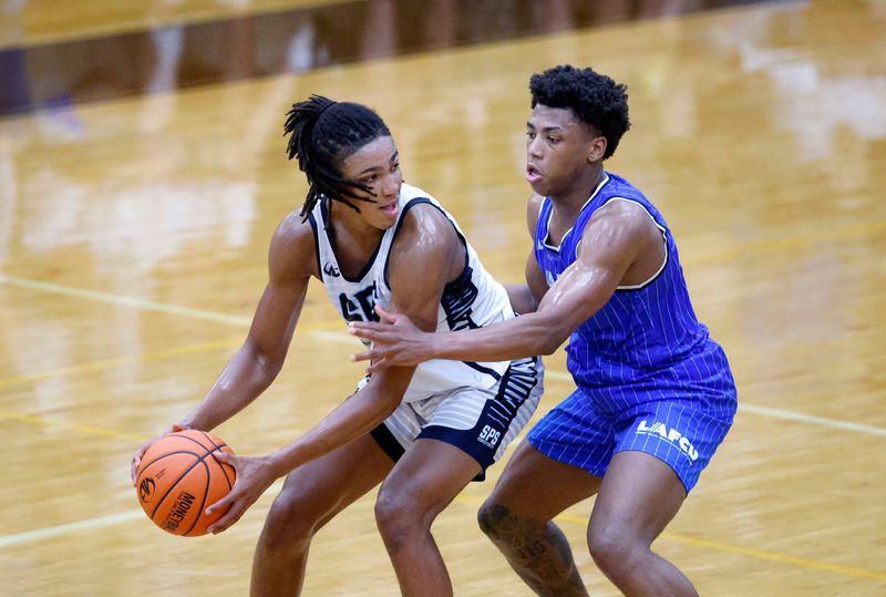 Team SPS and Michigan State's Jordan Scott, left, maneuvers against team LAFCU and Michigan State's Jeremy Fears Jr. during the Moneyball Pro-Am, Tuesday, July 7, 2026, at Holt High School.