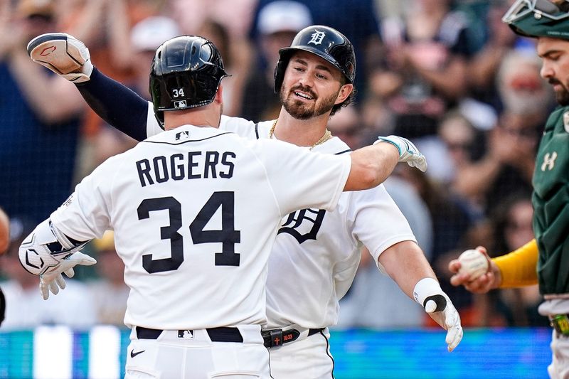 Tigers catcher Jake Rogers (34) celebrates his two-run home run against the Athletics with shortstop Zach McKinstry (39) during the second inning.