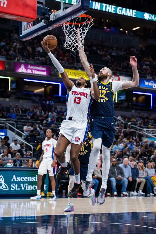 Pistons forward Isaac Jones (13) shoots the ball while Indiana Pacers center Jay Huff (32) defends in the second half at Gainbridge Fieldhouse.