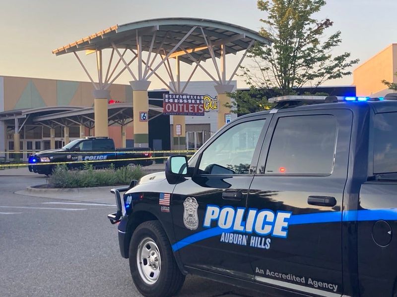 Multiple police vehicles seen outside the scene of a shooting incident at Great Lakes Crossing Outlets in Auburn Hills Saturday, July 11, 2026.