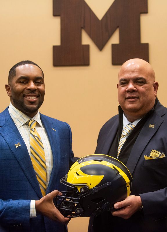 The University of Michigan's newly appointed head football coach, Sherrone Moore, left, poses for a photo with Athletic Director Warde Manuel, right, during a press conference on Saturday, Jan. 27, 2024 at the Junge Family Champions Center in Ann Arbor.