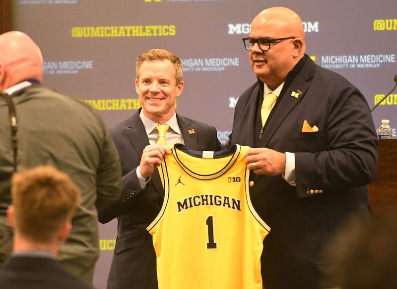 Michigan AD Warde Manuel, right, said it's "ridiculous" that he's blamed for Dusty May leaving for a head-coaching job in the NBA.
