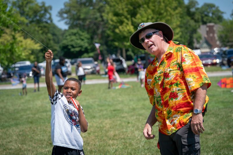 Davontaze Surgeon, 7, of Detroit, left, gets some pointers from veteran kite flyer Murray Irvin 69, of Ontario during the 8th annual Detroit Kite Festival that took place at Belle Isle on Sunday, June 12, 2026. Irvin voluntarily helped many first time kite flyers launch their kites “I do it for the smiles” said Irvin.