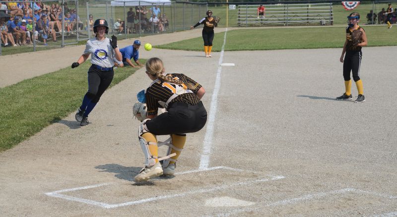 South Rockwood catcher Eliot Duffy prepares to tag Ida's Logan Everett out at the plate during an 11-1 Ida victory in the winners' bracket finals of the 52nd annual Monroe County Fair Softball Tournament on Tuesday, July 14, 2026.