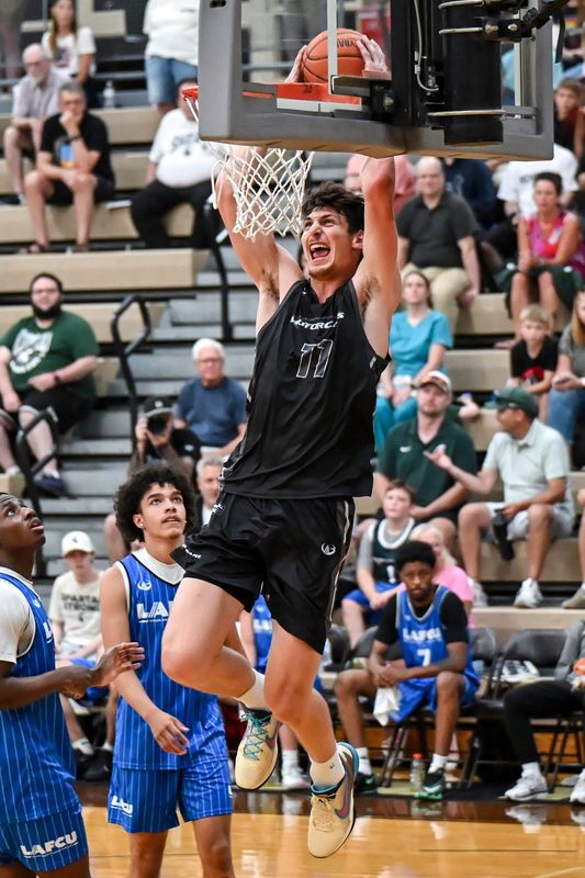 Team Motorcars’ and Michigan State's Anton Bonke dunks during the Moneyball Pro-Am on Tuesday, July, 14, 2026, at Holt High School.