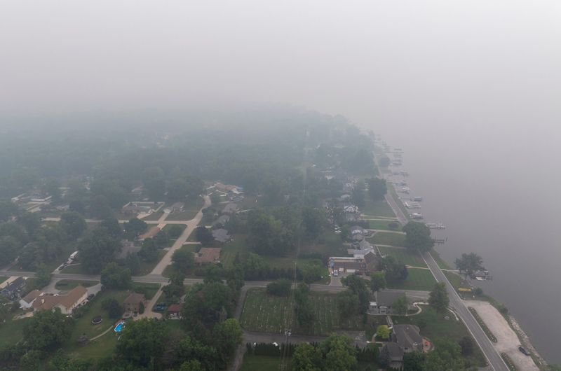 Wildfire smoke from Canada and Minnesota shrouds Grosse Ile and the Detroit River on July 16, 2026. Canadian experts said wildfires in their country are not controllable because of a variety of factors.