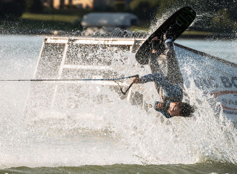 Silver Lake Ski Club member Aidan Hughes, 23, of Fenton, performs flips while being pulled from a boat across Silver Lake in Fenton during a weekly free ski show for the public by the Silver Lake Ski Club held at Silver Lake Park on Tuesday, July, 7, 2026.