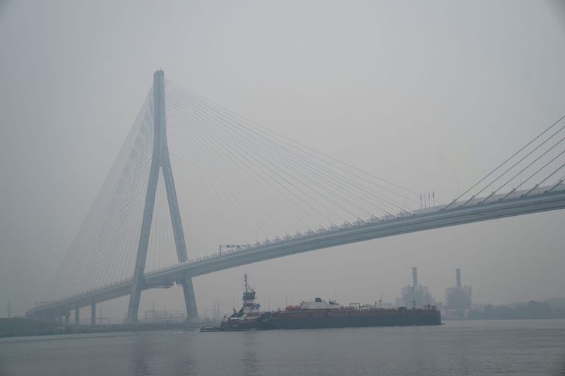 Thick smoke from Canadian wildfires blankets Metro Detroit as a freighter passes under the Gordie Howe International Bridge on Thursday, July 16, 2026.