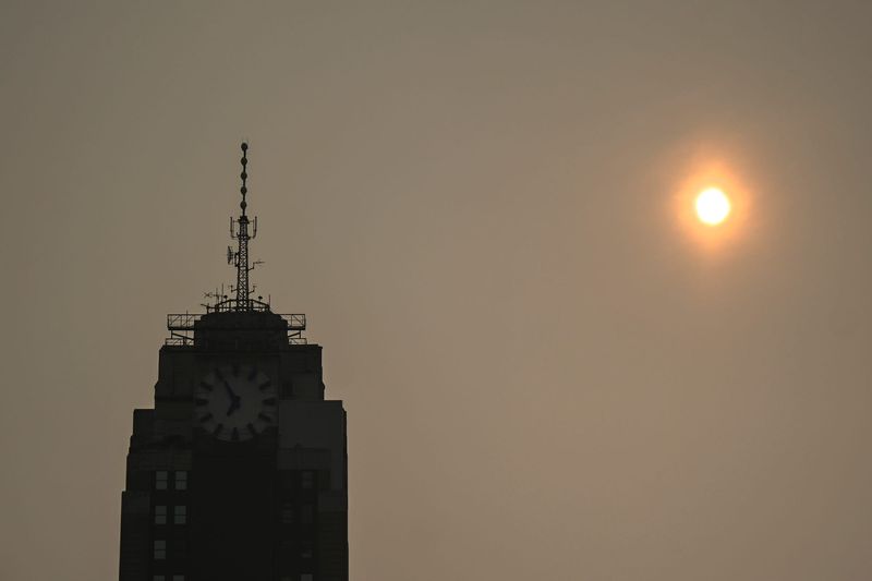 The sun is filtered by the thick smoke from the Canada and Minnesota wildfires on Thursday, July, 16, 2026, in Lansing.