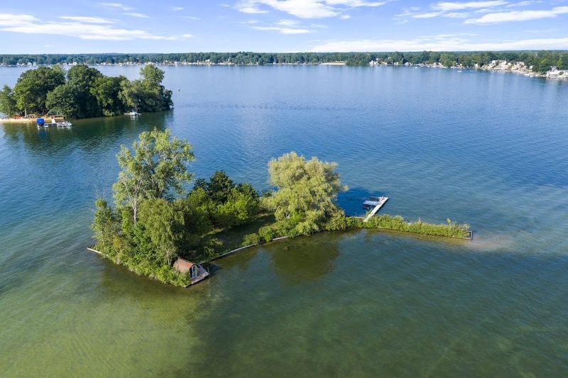 A small private island on Crystal Lake about an hour north of Lansing on the market for $199,900.
