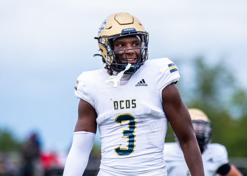Birmingham Detroit Country Day's Anthony Cartwright laughs with his coaches during a football game on Sept. 6, 2025, at Joseph P. Healey Field.