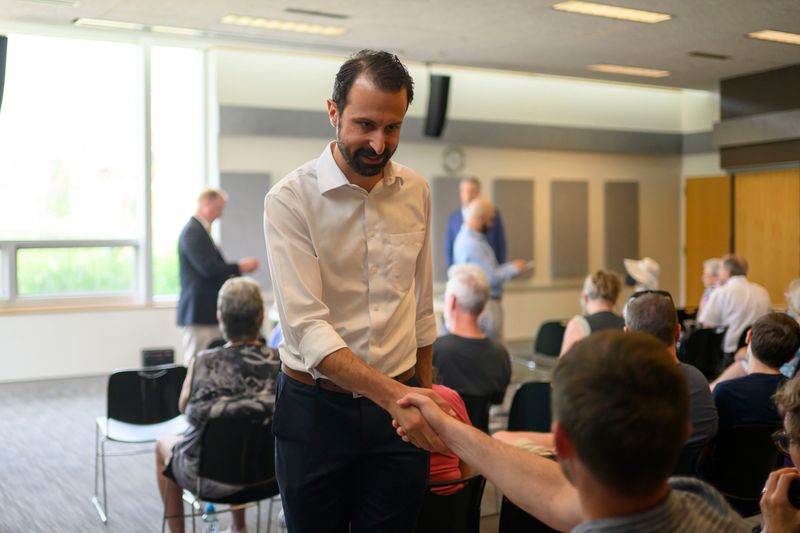 Mayoral candidate Yousef Rabhi greets the public during a candidate forum at the Traverwood Library, in Ann Arbor, July 19, 2026.