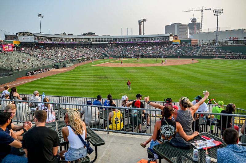 Fans take in the action from the outfield seats as the Lugnuts play the TinCaps during a 30th anniversary celebration game on Saturday, July 18, 2026, at Jackson Stadium in Lansing.