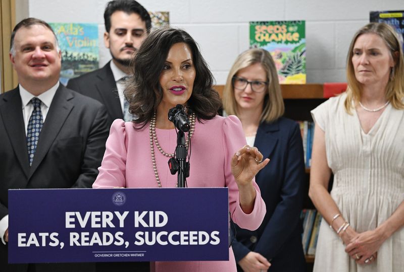 Gov. Gretchen Whitmer, (c), gives remarks before signing the education funding budget that funds K-12 schools, community colleges and four-year public universities, at Alder Elementary School on Tuesday, July 21, 2026, in Southfield, MI.