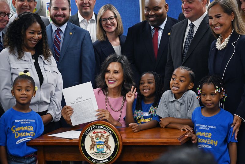Gov. Gretchen Whitmer, center, signed the education funding budget that funds K-12 schools, community colleges and four-year public universities at Alder Elementary School in Southfield on July 21, 2026. The Citizens Research Council estimates the latest state budget has a $600 million to $900 million shortfall.