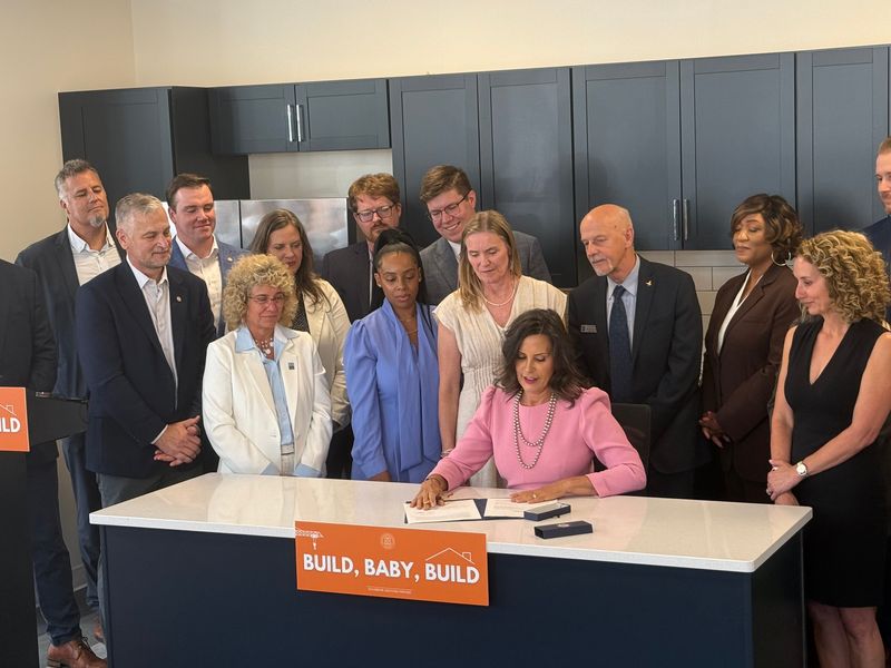 Gov. Gretchen Whitmer, joined by lawmakers, signs legislation aimed at expanding housing construction on Tuesday, July 21, 2026, in Grand Rapids, Mich.