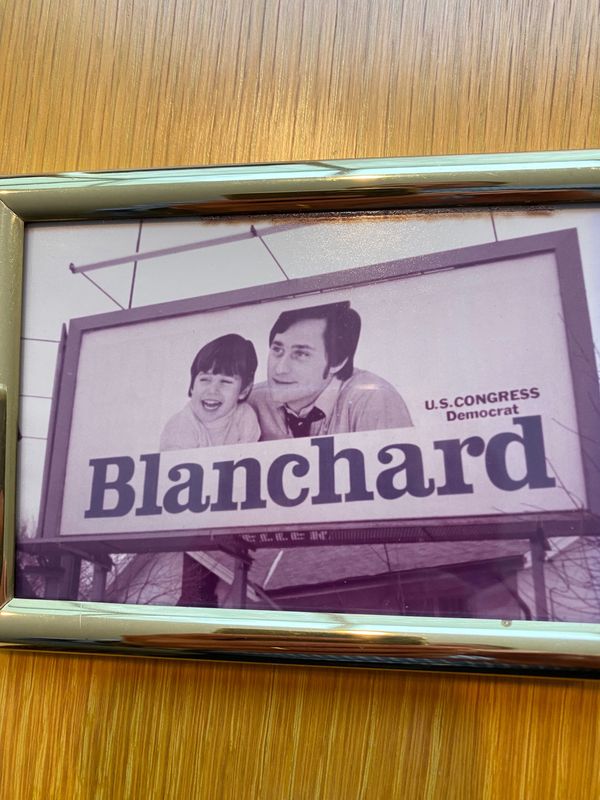 Framed photograph of Jim Blanchard's first official billboard when he ran for Congress. Blanchard hired (the late) Bob Benyas of Royal Oak to take the photo of Blanchard and son Jay, who was 3 at the time.
