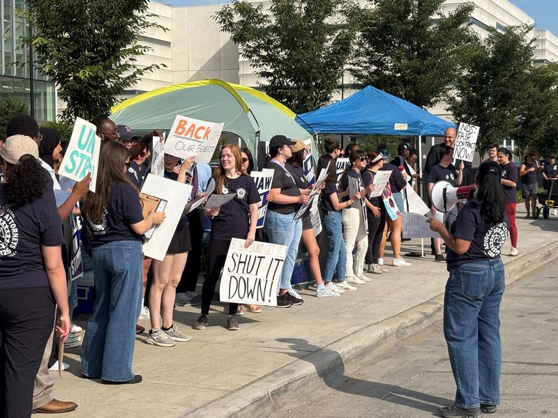 Members of Neighborhood Defender Service who represent low-income individuals in court cases walk the picket line outside of Third Circuit Court on Russell in downtown Detroit on Friday, July 24, 2026.