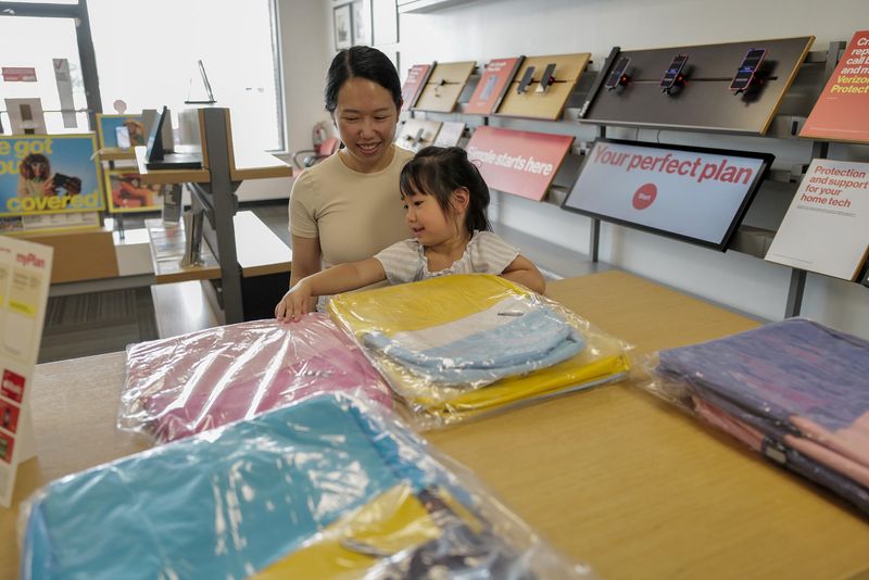 Four-year-old Nancy Dam, and her mom Ly Mai from Lansing pick out a backpack at the Verizon Store in DeWitt as part of an annual free backpack giveaway Sunday, July 26, 2026.