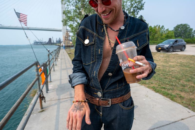 Anthony Scannell, Detroit, shows off his maple leaf tattoo as he came straight from work to see the Gordie Howe Bridge, Monday, July 27, 2026, at Delray Public Access Boat Launch in Detroit. The bridge is scheduled to open today. When asked if he was there for the festivities Scannell laughed and said "I am the festivities."