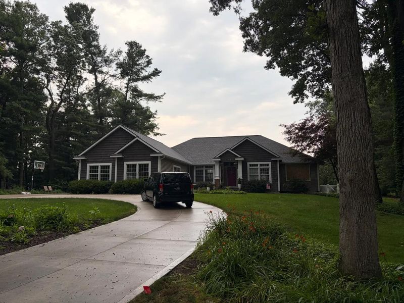 A car is parked outside the Karolkiewicz family home in Grand Haven Township after the entire family, both parents and six kids, were found dead on Friday, July 24, 2026.