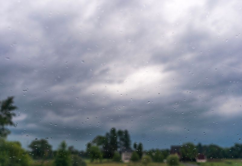 Rain drops collect on a windshield as storm clouds are seen above John Fries Highway in Quakertown on July 28, 2026.