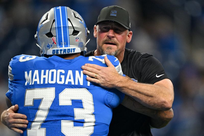 Sep 14, 2025; Detroit, Michigan, USA; Detroit Lions head coach Dan Campbell greets guard Christian Mahogany (73) during warmups prior to the game against the Chicago Bears at Ford Field. Mandatory Credit: Lon Horwedel-Imagn Images