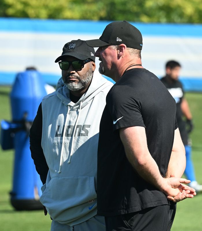 Executive vice president and general manager Brad Holmes and head coach Dan Campbell on the field during Lions training camp.