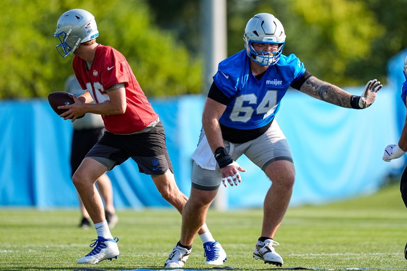 Detroit Lions center Cade Mays (64), center, practices with quarterback Jared Goff (16)  during training camp at Meijer Performance Center in Allen Park on Thursday, July 30, 2026.