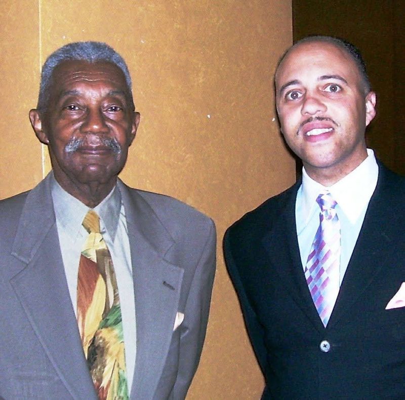 From childhood and through his adult years, up to this moment, Mark Elzy, right, is reminded of the importance of community service whenever he thinks of his father, the late Gene Elzy, who entertained Detroit radio listeners for more than 45 years.